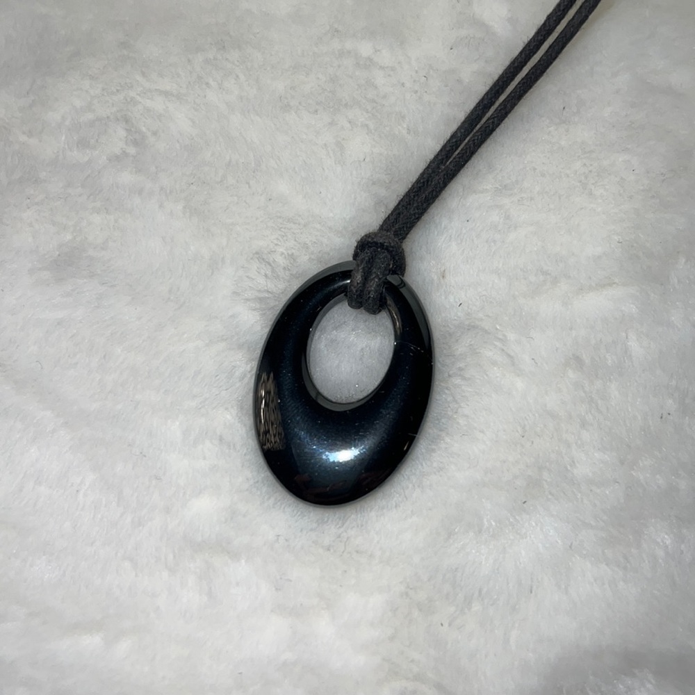 Craved stone pendant on leather cord